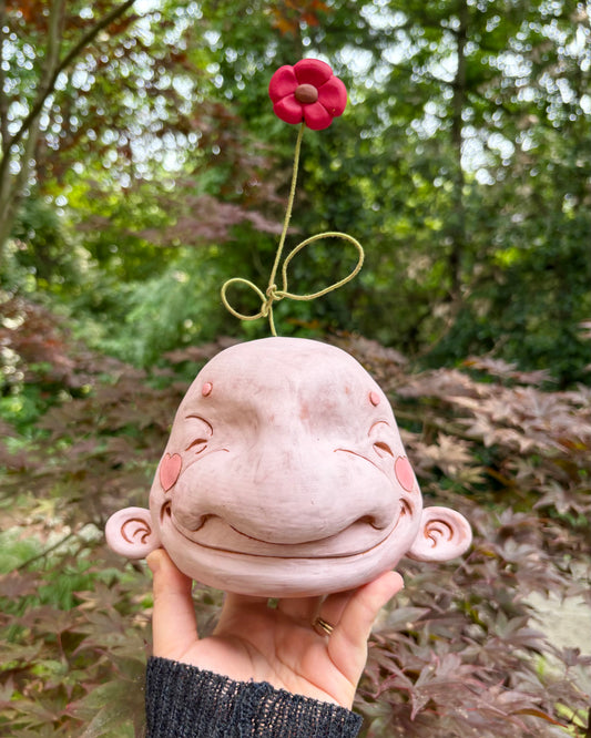 Light Pink Happy Head With A Flower